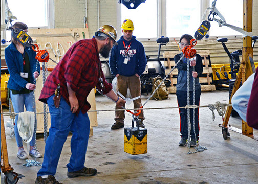 Riggers and students performing weight load test